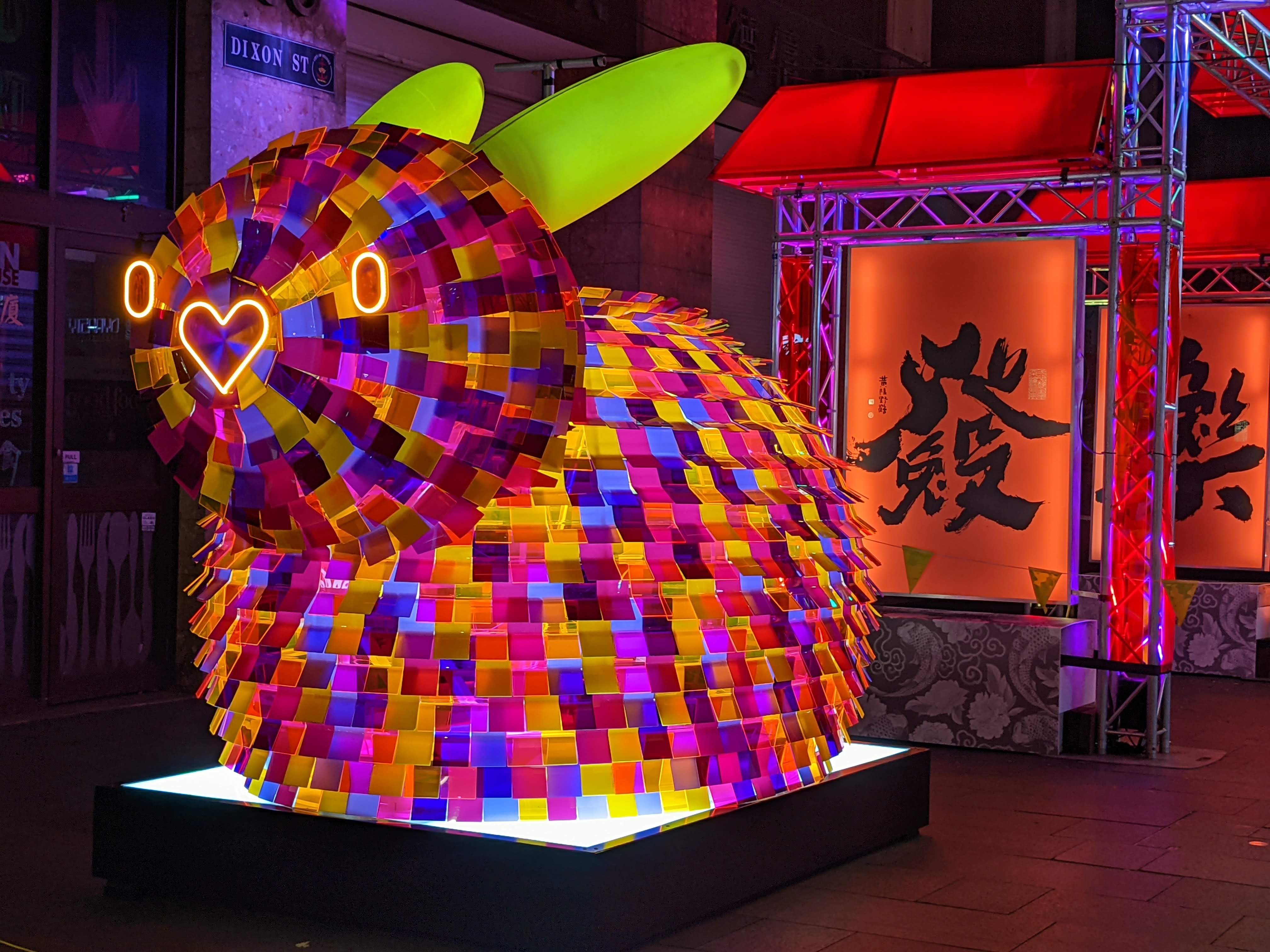Rabbit public artwork illuminated at night.